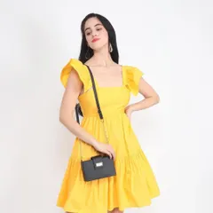 A model wearing a bright yellow summer dress and carrying a small handbag. This type of e-commerce photography shows how different items can be styled together, providing inspiration for shoppers.