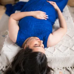 An artistic overhead shot that emphasizes the beautiful shape of pregnancy. This perspective offers a unique and intimate view, focusing on the mother-to-be in a moment of quiet reflection.