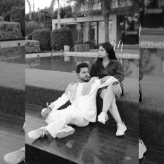 A chic black and white photo of a couple relaxing by a pool, capturing a moment of quiet connection in a modern, luxurious setting.