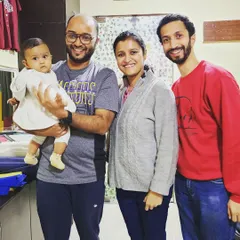 A photo of the new parents visiting our studio with their baby. We consider it a privilege to support families during this transformative time, providing guidance that extends beyond physical asanas.