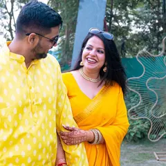 A happy, walking shot where the couple is color-coordinated in bright yellow. Their joyful expressions and easy stride make for a perfect candid portrait.
