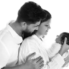 A tender moment between new parents as they gaze at their baby. These high-contrast, black and white photos are memories to last forever.