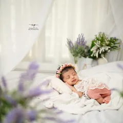 A sweet sleeping baby, smiling in her dreams. I aim to capture these fleeting, precious moments of pure peace during our newborn sessions.