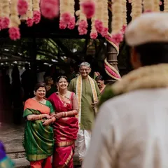 The bride's emotional entrance with her parents. This shot captures the pride and love in their eyes as they walk their daughter down the aisle.