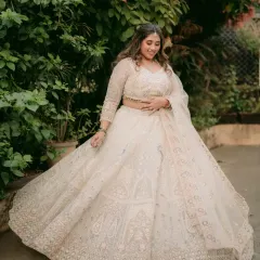 A full-length shot showing how the soft makeup look perfectly complements her intricate white lehenga.