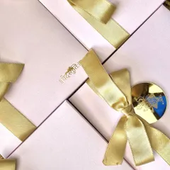 Nothing says luxury like a boxed invitation. This design features elegant pink boxes with custom gold foil monograms and satin ribbons, creating a truly special unboxing experience for guests.