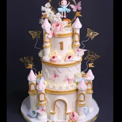 The art that signifies pure love. I designed this grand castle cake for a precious first birthday, complete with a swinging doll topper, golden butterflies, and soft lights to make it truly special.