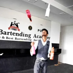 Capturing the peak of the action, our flair bartenders masterfully juggle multiple bottles. It's a display of precision and practice that elevates any party.