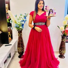 A gorgeous wine-colored ball gown for a special celebration. This client looks radiant holding a custom cake, making her birthday even more memorable.