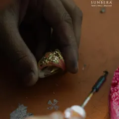 Here, an artisan is engaged in the delicate process of wax modeling for a custom gold ring. This is one of the first steps in turning a client's unique design idea into a tangible piece of jewellery.