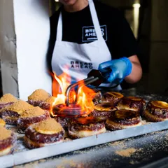 Fire adds so much drama to food photography. Here, I captured the moment a blowtorch caramelizes the sugar on donuts at Bread Ahead Bakery, creating a visually exciting and appetizing action shot.