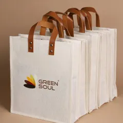 A lineup of sturdy, custom-branded tote bags ready for a bulk corporate order. I ensure consistency and quality, no matter the order size.
