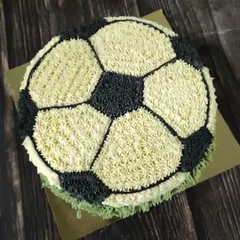 This all-buttercream football cake was so much fun to create. I used a star piping tip to make tiny dollops of black and white frosting, building up the classic soccer ball pattern for a true sports fan's celebration.