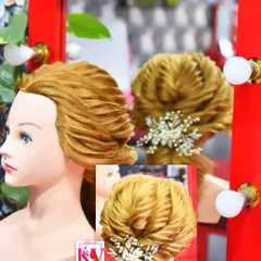A beautifully structured and textured low bun. This advanced hairstyle is secured with a sparkling brooch, demonstrating the clean and precise work I teach my students.