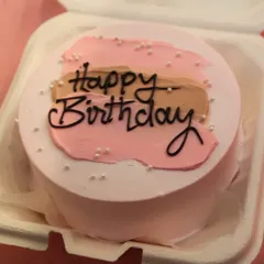 A classic "Happy Birthday" bento cake. The simple, elegant design with pink and brown frosting shows how we can personalize these mini treats for any birthday.
