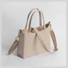 The side profile of the handbag, showing the strap attachments and overall depth.
