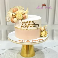 An elegant and classy birthday cake for 'Aai & Pappa', adorned with soft pastel tones, delicate roses, and golden accents.