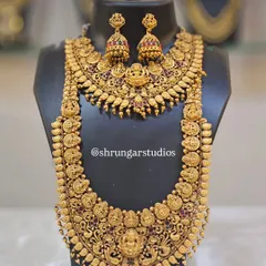 Feel like a goddess on your special day with our intricate temple jewellery. This full bridal set includes a choker and a long haar, both featuring detailed carvings of deities like Goddess Lakshmi, finished in an antique gold polish. This is a very popular choice for South Indian bridal looks and traditional ceremonies.