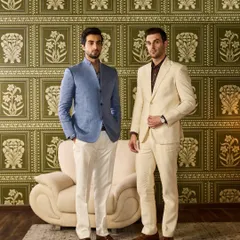 A full-length shot of the two groomsmen, demonstrating how different styles in a coordinated color palette can create a polished and harmonious look for the wedding party.