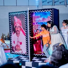 A family member interacts with the photo reveal book, a custom piece of interactive decor that added a personal touch to the celebration.