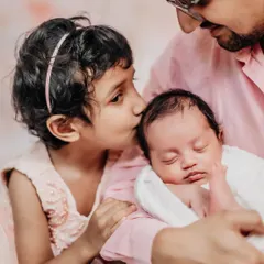 A gentle kiss for the new baby from a proud big sister. Capturing the beginning of this lifelong bond is one of the most rewarding parts of my job.