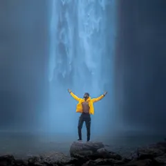 Standing in awe before a powerful waterfall in Meghalaya. This shot captures the feeling of being small in the face of nature's immense power and beauty.
