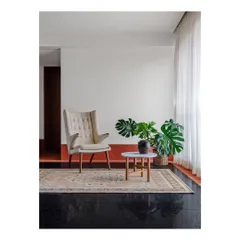 We create small, interesting moments throughout a home. This corner in the Ved House, with its comfortable wingback chair and indoor plant, becomes a perfect spot for reading and quiet contemplation.