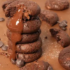 So gooey, so soft, a chocolate lover's dream. My Double Chocolate Chip Cookies are made to satisfy your deepest chocolate cravings, shown here with a decadent chocolate drizzle.