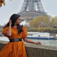 We love seeing our creations travel the world. Here is our wonderful client looking effortlessly chic in our custom orange puff-sleeve dress against the iconic backdrop of the Eiffel Tower in Paris. This is the perfect example of our versatile vacation wear.