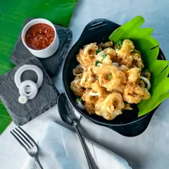 Our crispy fried squid is a crowd favorite. Tossed in butter and garlic, these golden rings are incredibly addictive and served with a spicy dip to complement the flavor.