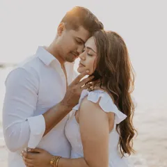 An intimate close-up of a couple on a Goan beach at sunset. The warm light and gentle touch create a deeply romantic and candid portrait, filled with emotion.