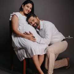 An intimate and loving pose in the studio. The partner kneeling to listen to the baby bump is a classic shot that I love to capture for its emotional impact.