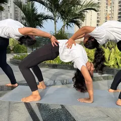 This is the same group wheel pose from a different angle, highlighting the alignment and shared effort. It's a testament to how we can lift each other up in our practice.
