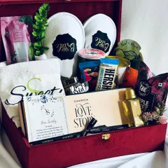 A look inside our ultimate bridal hamper. This red velvet box is packed with a personalized towel, "Bride" slippers, a "Love Story" gift set, premium chocolates, and skincare essentials.