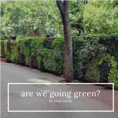 A long outdoor vertical garden lines a walkway, transforming a simple path into a green corridor. This installation uses a variety of hardy plants to create a rich, textured, and resilient outdoor feature.
