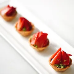 Bite-sized strawberry tartlets, ideal for parties and events. These mini treats offer the same delicious flavor in a convenient, shareable format.