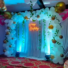 This image shows the scale of our birthday arch, perfect for creating a focal point in a party hall or a large room. We ensure every detail, from the lighting to the balloon placement, is just right.