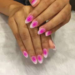 This is the popular aura nail trend. This set features a vibrant pink aura gradient on a white base, creating a soft, glowing effect on almond-shaped nails.