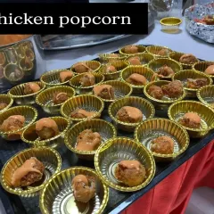 Bite sized chicken popcorn served in individual cups with a drizzle of sauce. This is a popular and convenient starter, especially for birthday parties and casual events.