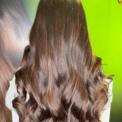 The stunning "after" result. A deep base melts into beautiful wine red ends, styled with voluminous waves.