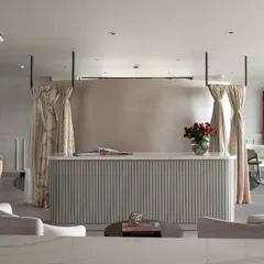 This is the reception area of our Hyderabad Experience Center, designed to showcase a blend of textures. The fluted paneling on the desk, soft custom drapes, and plush seating create a layered and inviting atmosphere, giving clients a tangible sense of the quality I deliver.