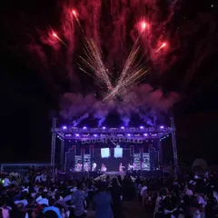 Stepping into the spotlight and into forever. A wide shot of the Sangeet stage with massive trusses, professional lighting, and a huge fireworks display, showcasing the concert-level production I deliver.