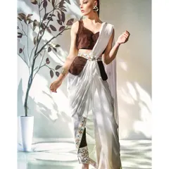 A beautiful blend of modern fashion and minimal art. This shot uses hard, directional light to create dramatic shadows that complement the contemporary drape of the saree.