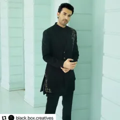 A modern and stylish look for an editorial shoot. The grooming is minimal and masculine, focusing on flawless skin and perfectly styled hair to complement the Indo-western outfit.