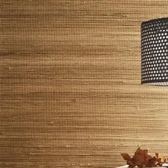 A close-up of a natural fiber wallcovering from the Intuition collection. The woven texture adds depth and a tactile quality to the wall, creating a cozy and high-end feel.