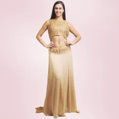 A model showcasing a stylish gold two-piece set. This outfit includes a textured crop top and a flowing skirt, designed for a modern and glamorous party look.