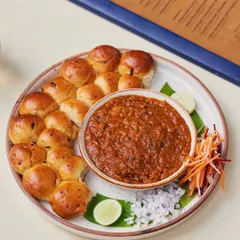 A close-up of the star of our Pav Bhaji. These buttery, pull-apart paos are baked fresh in-house and served warm, ready to scoop up the rich and flavorful bhaji.
