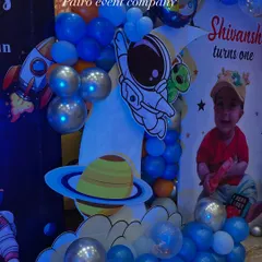 A close-up of the space-themed decor, highlighting the astronaut and alien cutouts, planet details, and shiny silver balloons.