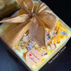 My Rasmalai Cake Tub, beautifully packaged with a gold ribbon. This Indian fusion dessert makes a wonderful gift for festivals and special occasions.