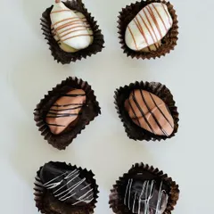 Simple, elegant, and delicious. These are my handmade chocolates for Diwali, featuring white, milk, and dark chocolate varieties with a decorative drizzle on top.